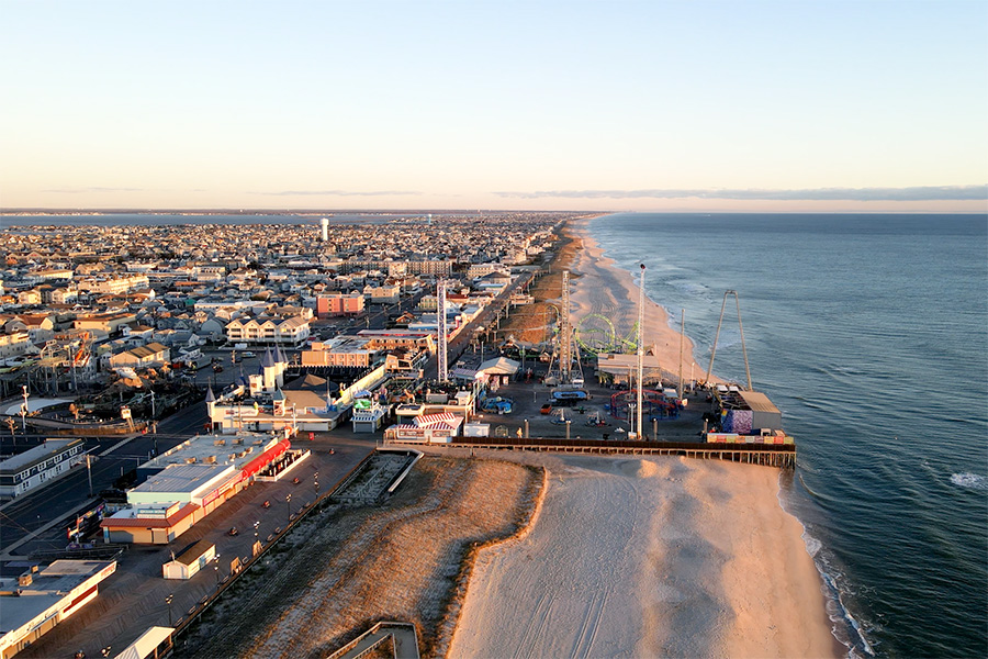 aerial drone shot of a amusement park boardwalk on the jersey shore